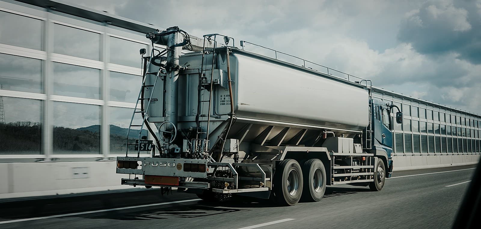 A tanker truck parked beside a warehouse