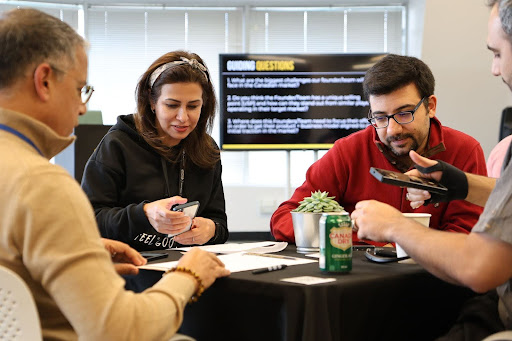 group of people sitting at a table and talking